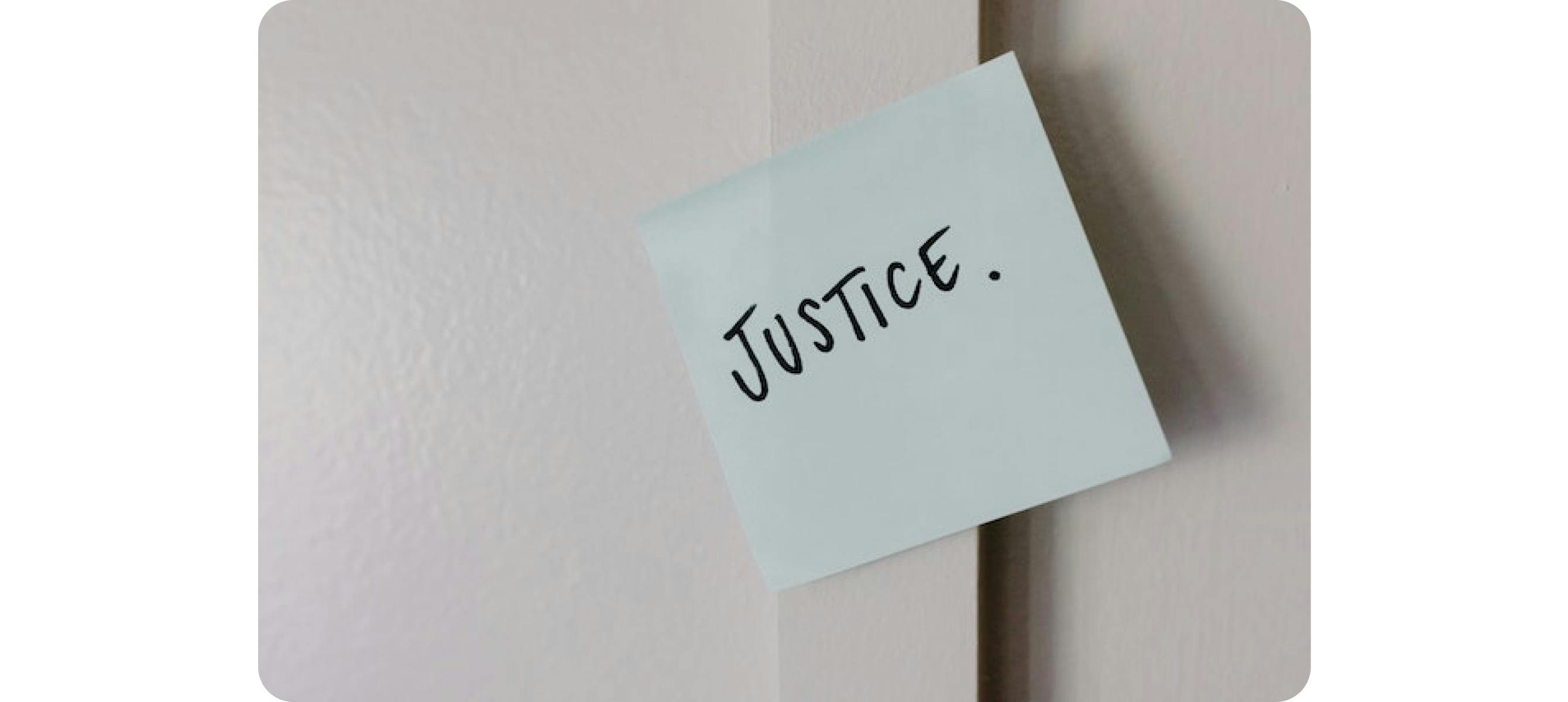 a paper on the wall with the word justice