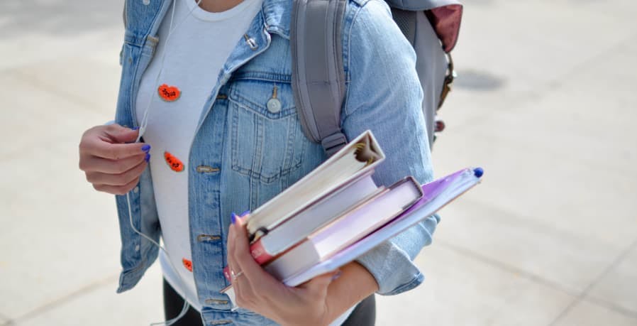 school girl carrying books