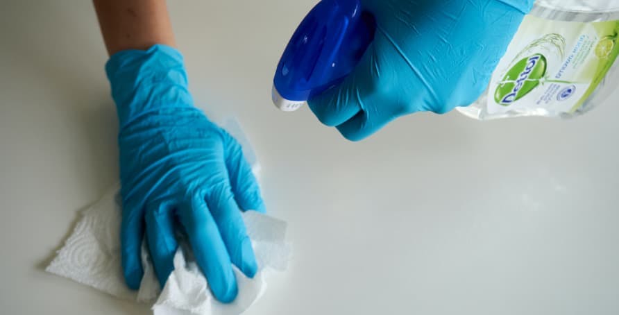 blue rubber gloves and cleaning supplies
