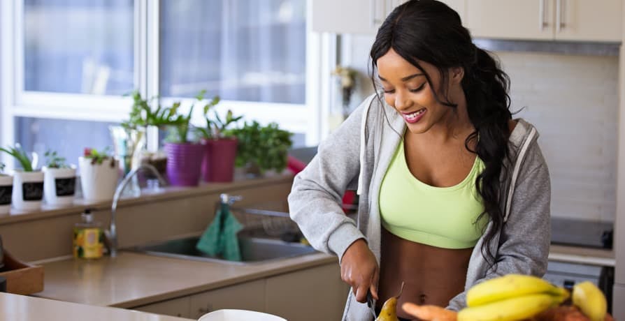 person cutting up fruit