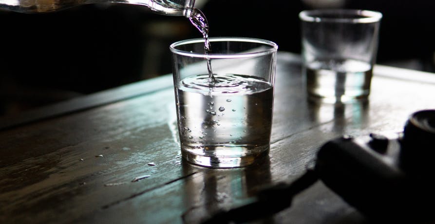 pouring water into a glass