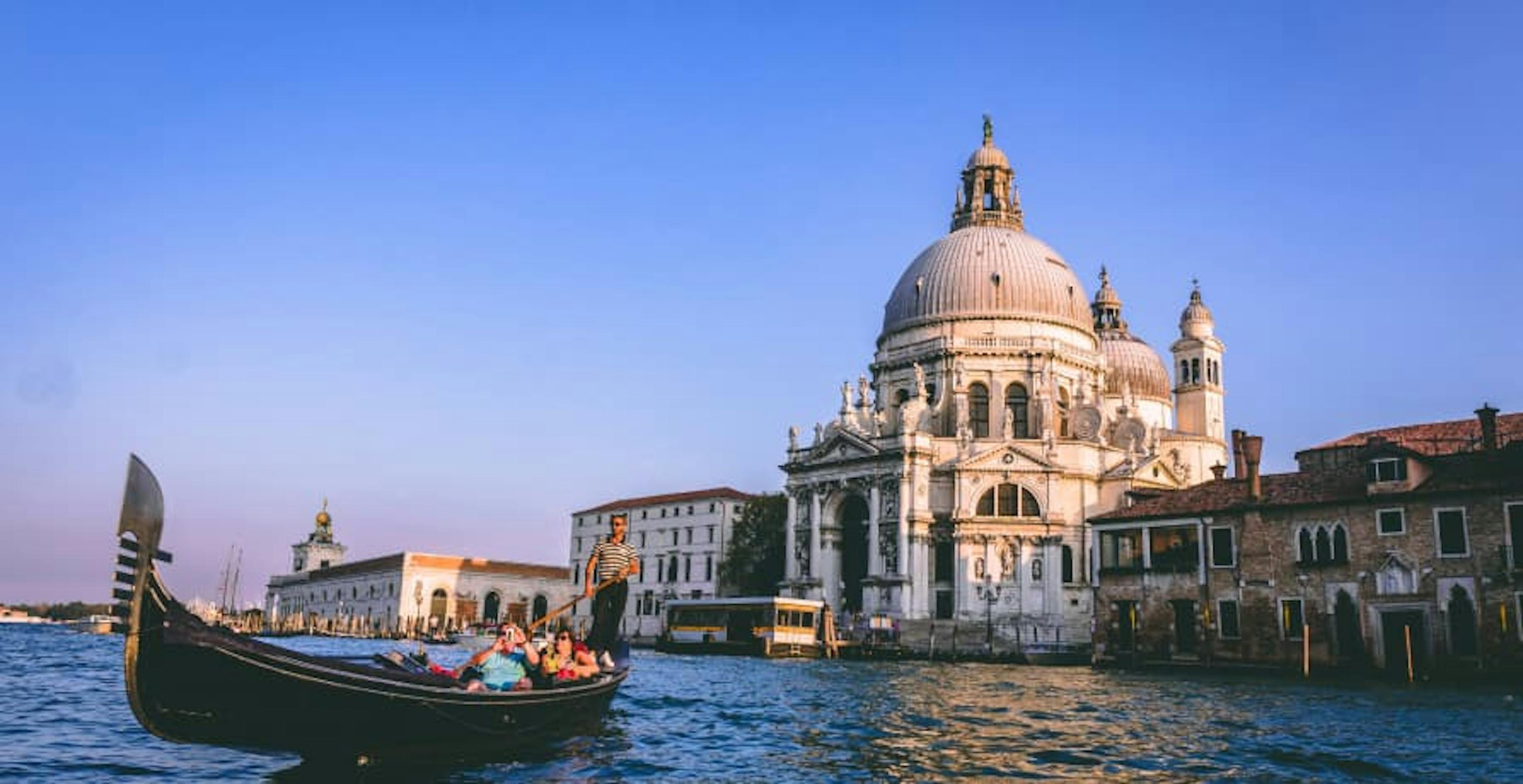 Venice lagoon with historic buildings and boat 