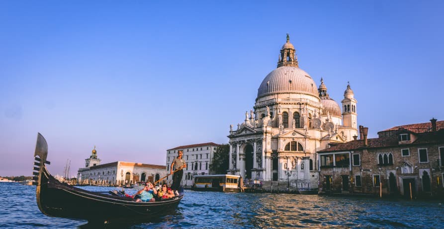 Venice lagoon with historic buildings and boat