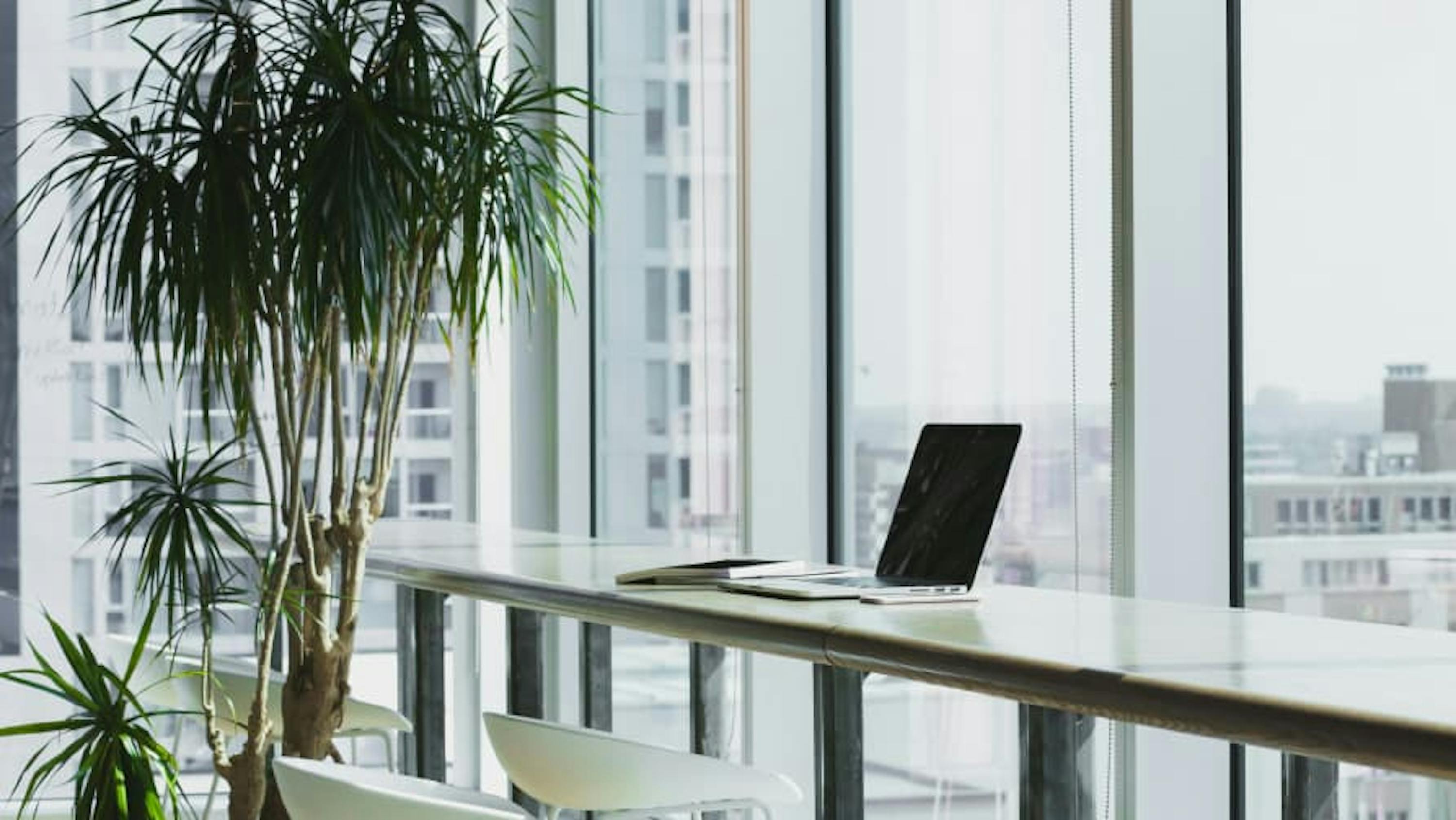 laptop sitting at glass window