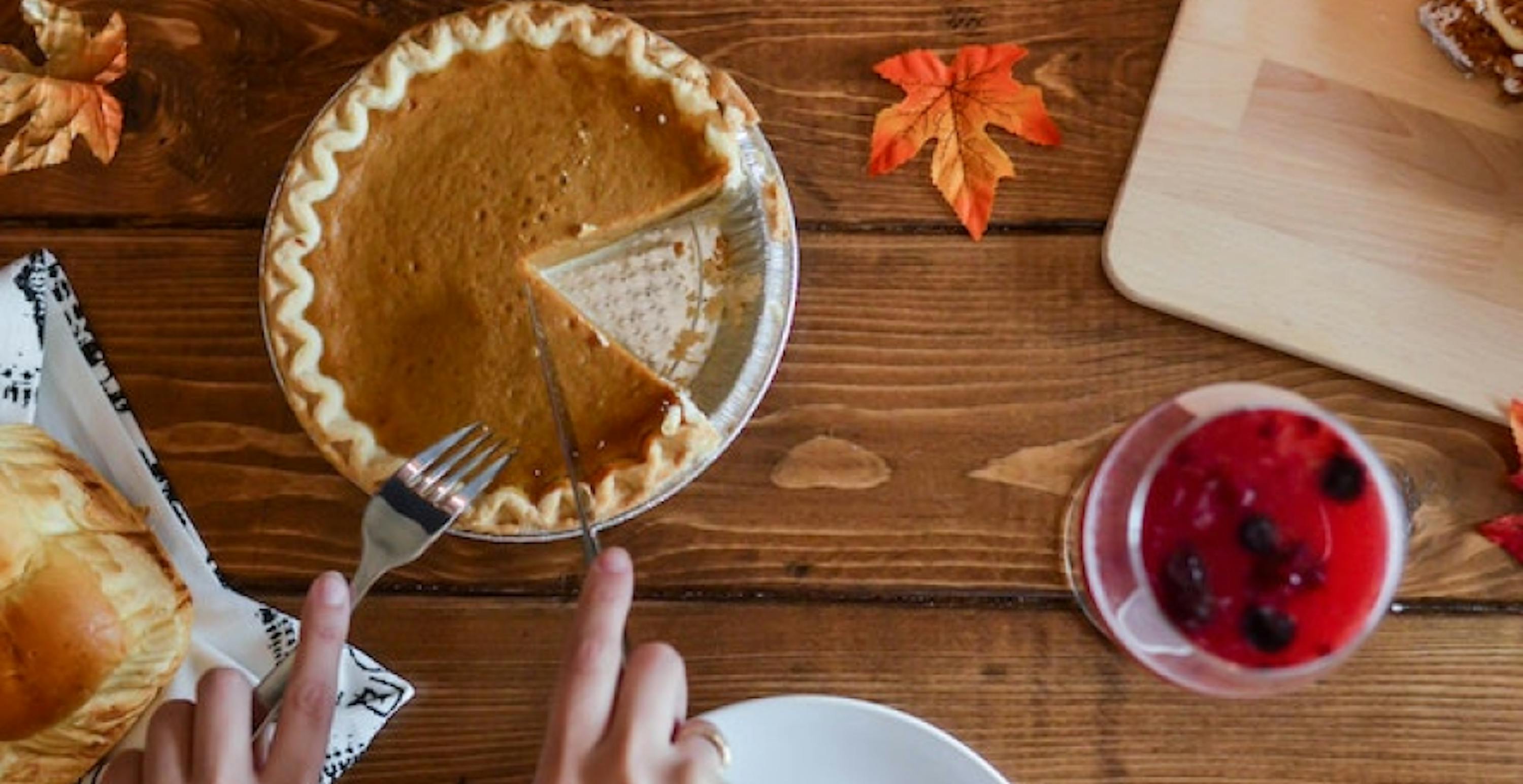 cutting a slice of pumpkin pie