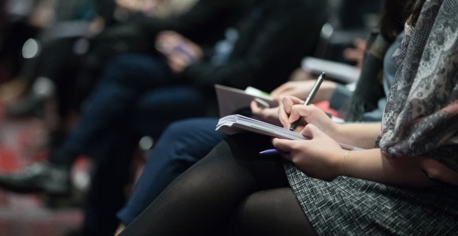 journalist jotting things down on a notepad