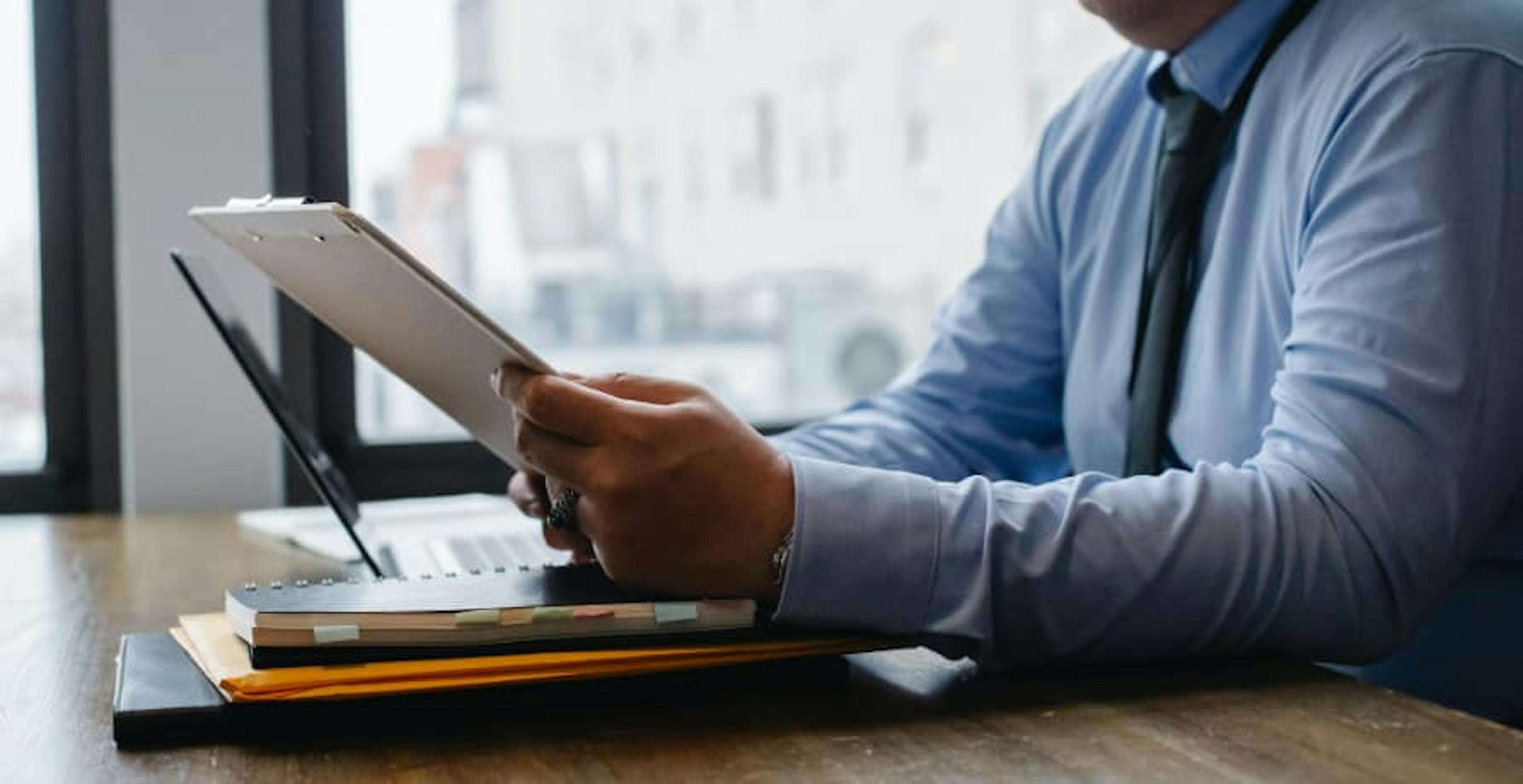 man in a suit reading a document