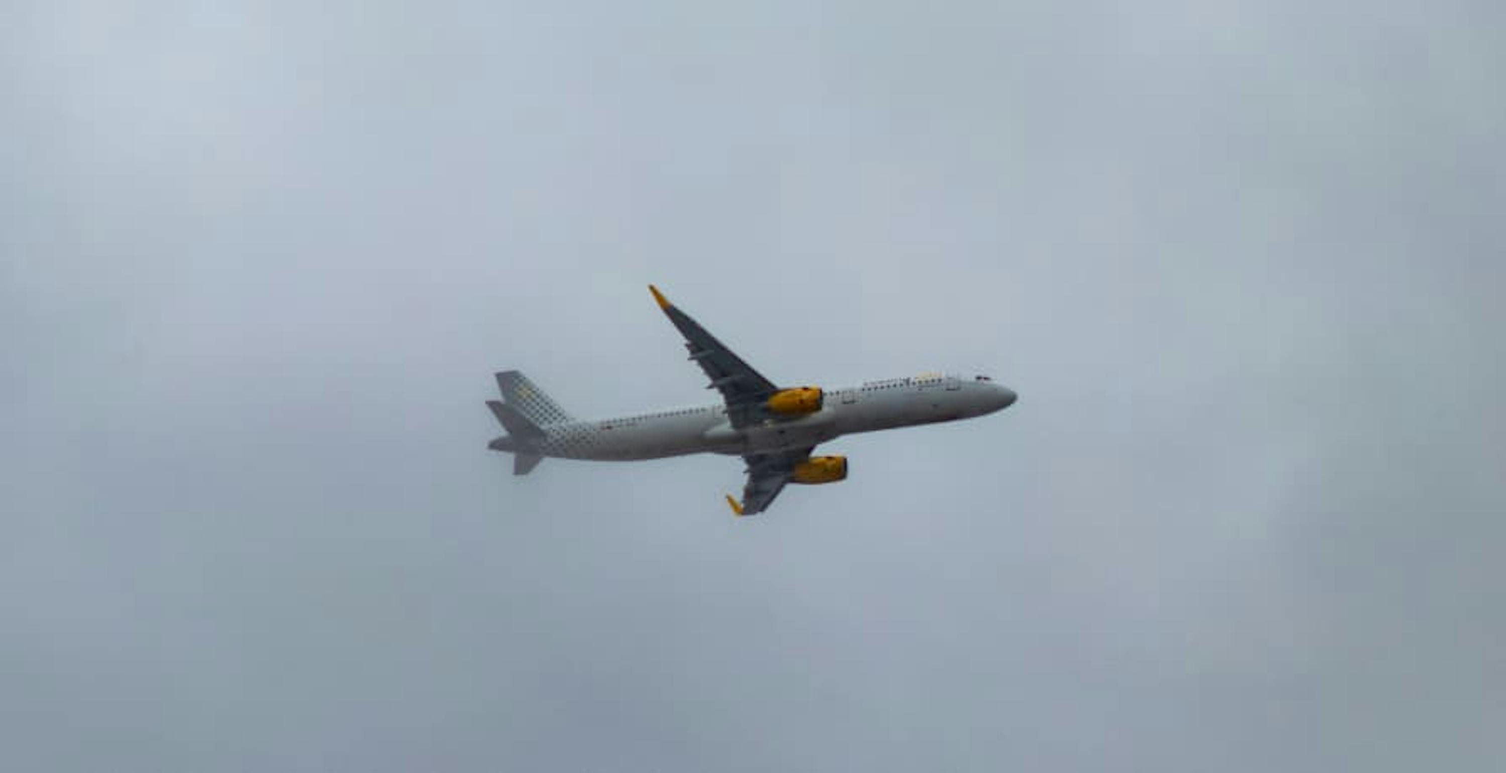 plane flying in the cloudy sky