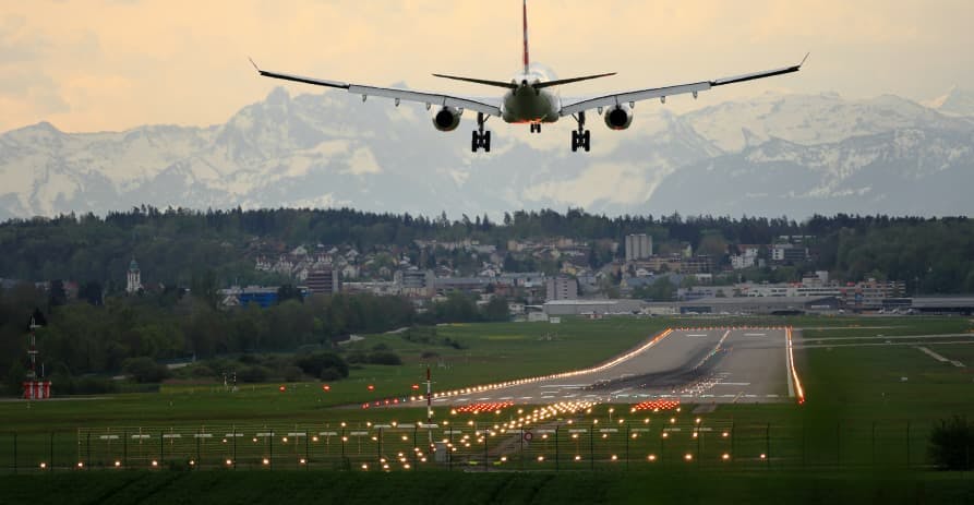 airplane landing in mountainous city