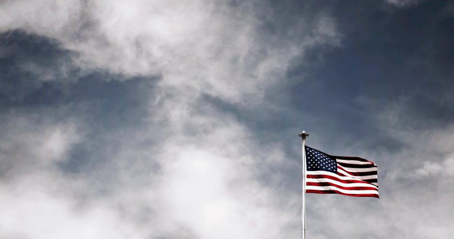 American flag in dreary sky 