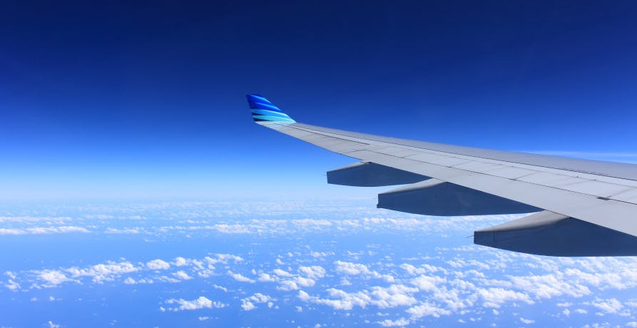 View of an airplane wing and blue sky