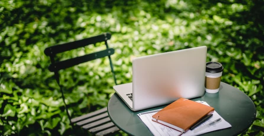 computer notebook and coffee on bryant park nyc chair