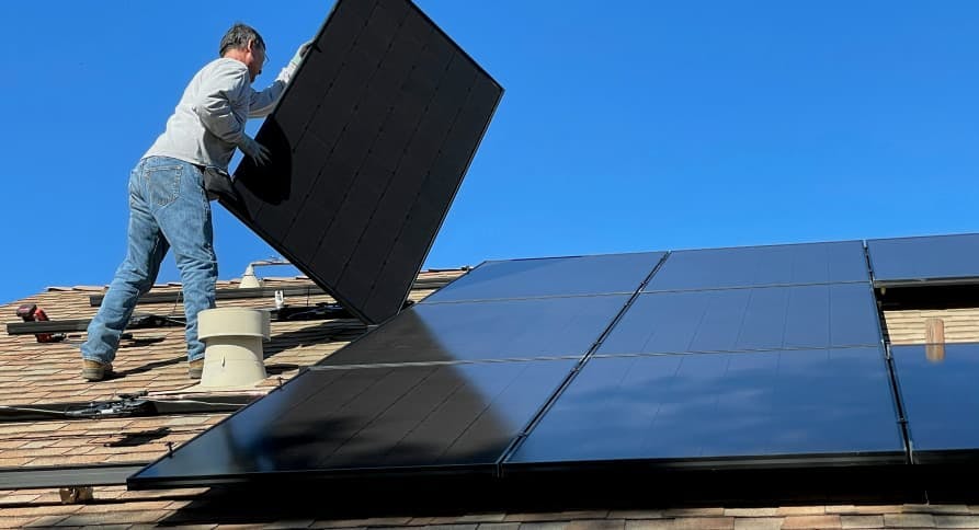 person constructing solar panels