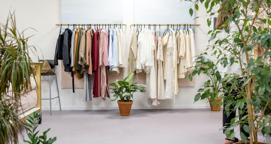 clothes on rack surrounded by plants