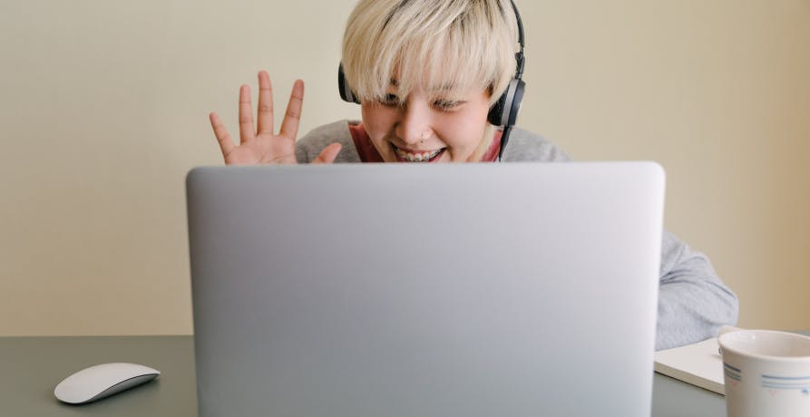 woman waving on video conference