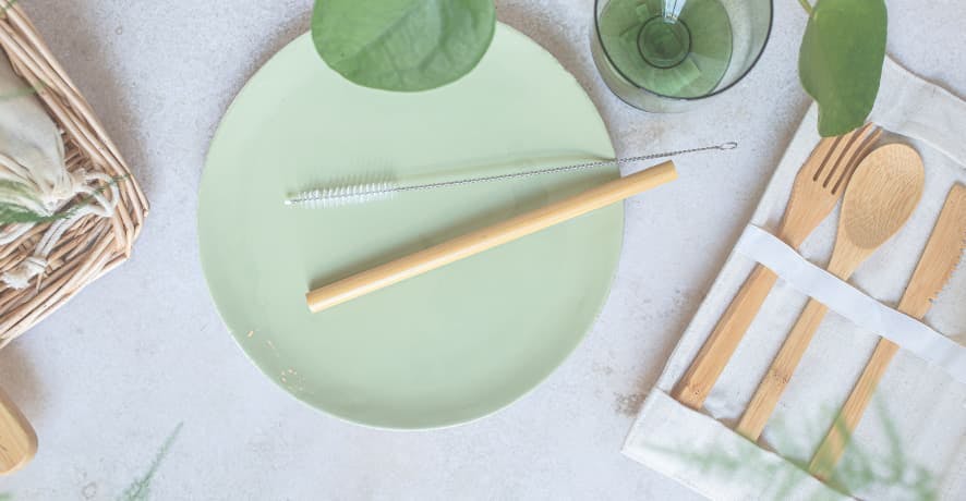 light green plates with bamboo utensils