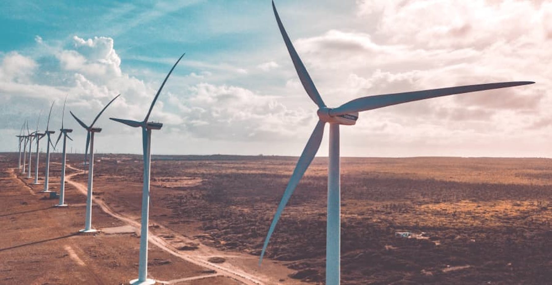 wind turbines up close in dry area