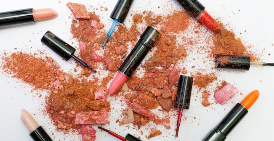 lipsticks open and crushed powder