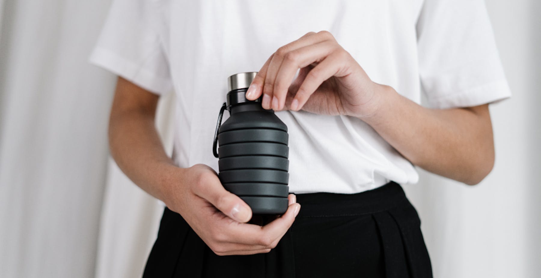 person holding reusable water bottle 