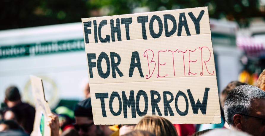 climate change protesters holding up a sign