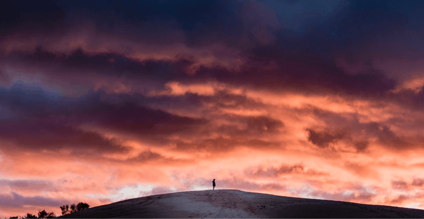 person standing on hill in sunset