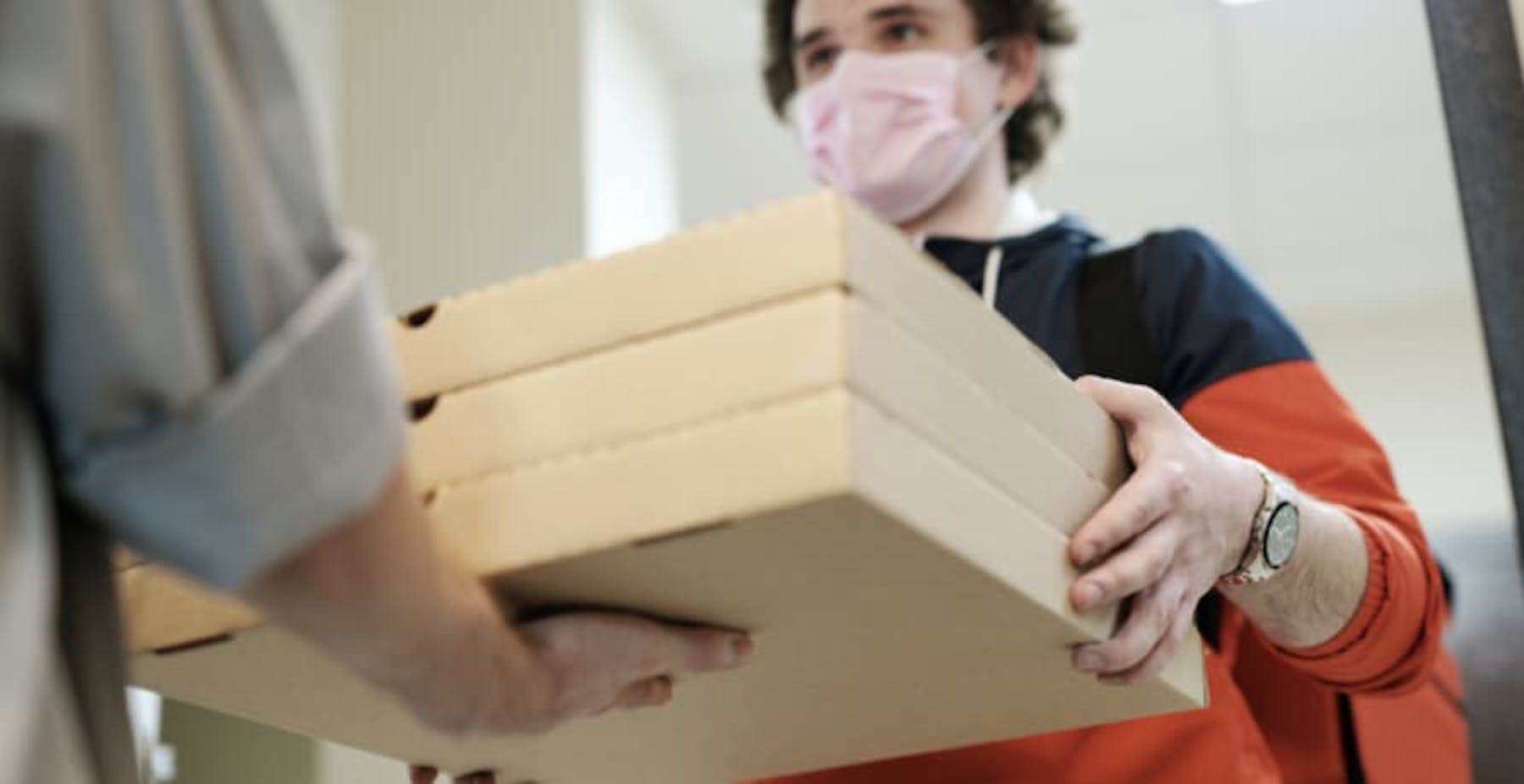 a man delivering pizzas
