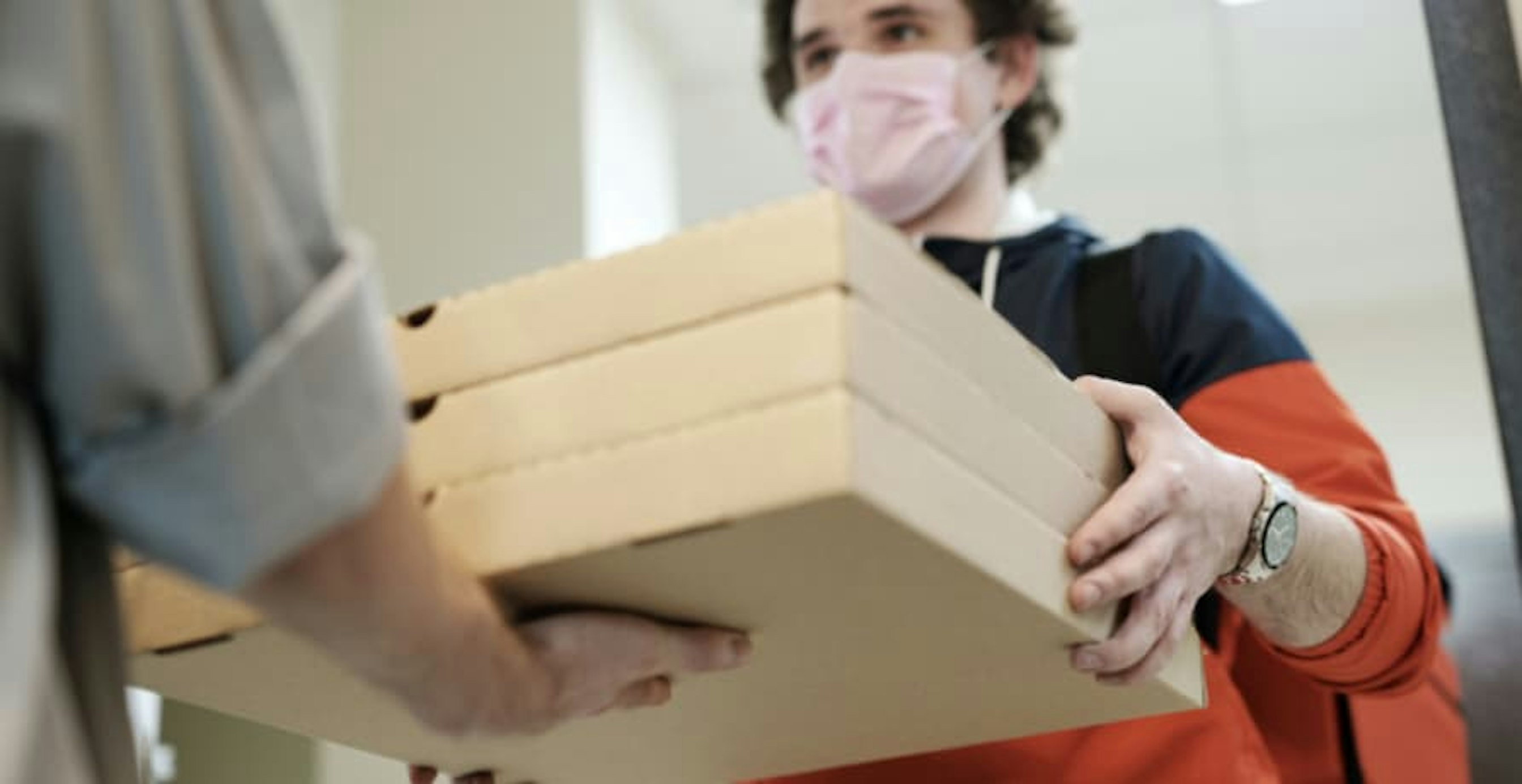 a man delivering pizzas