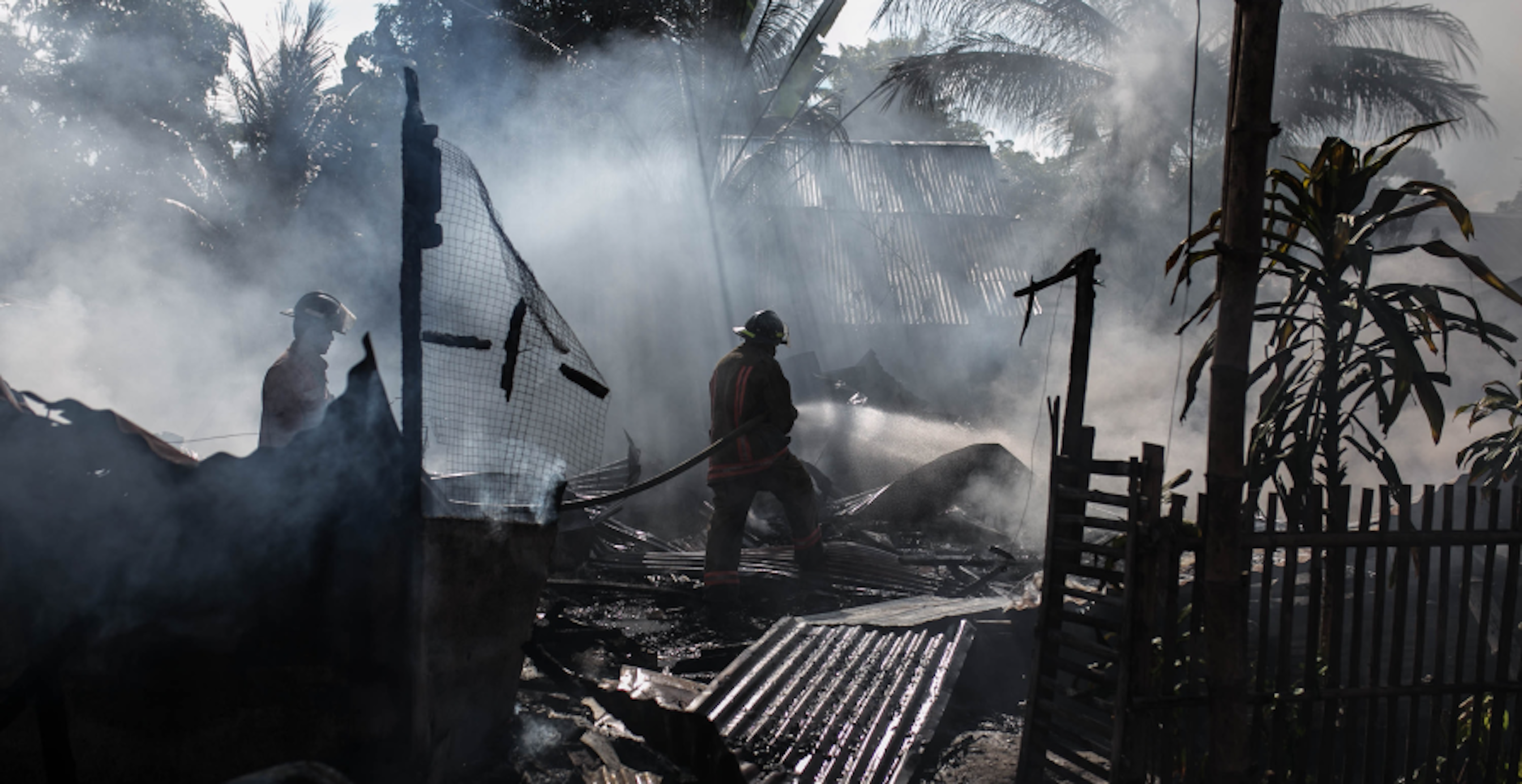 natural disaster with debris and people walking around