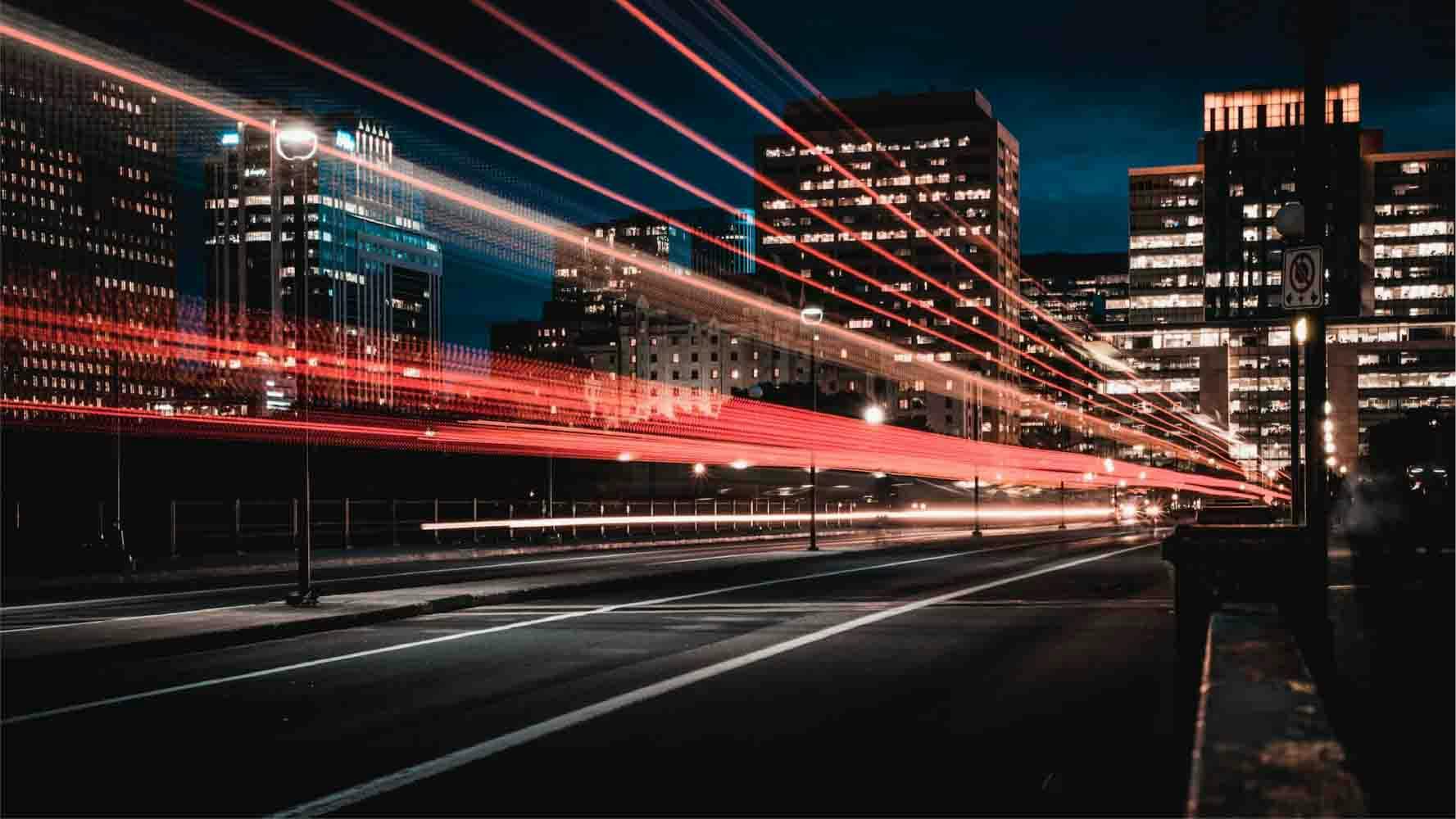 Long exposure photography of road and cars in a city by night