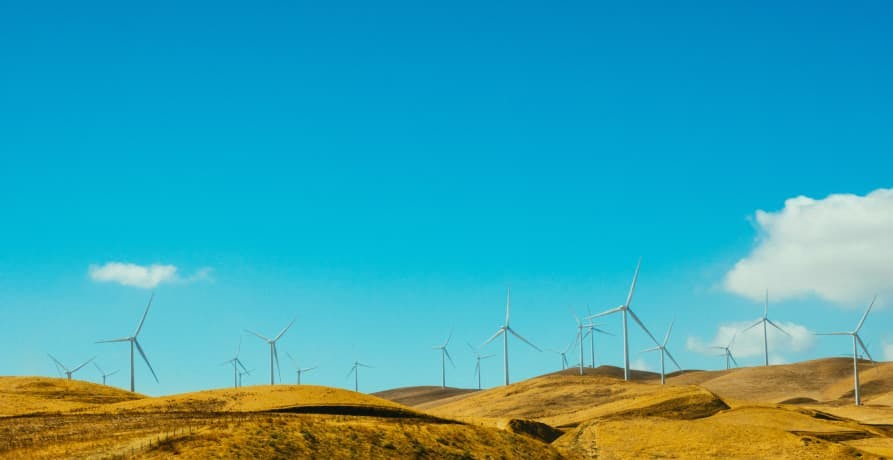 wind turbine farm in the countryside with blue skies