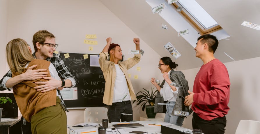employees celebrating inside meeting room