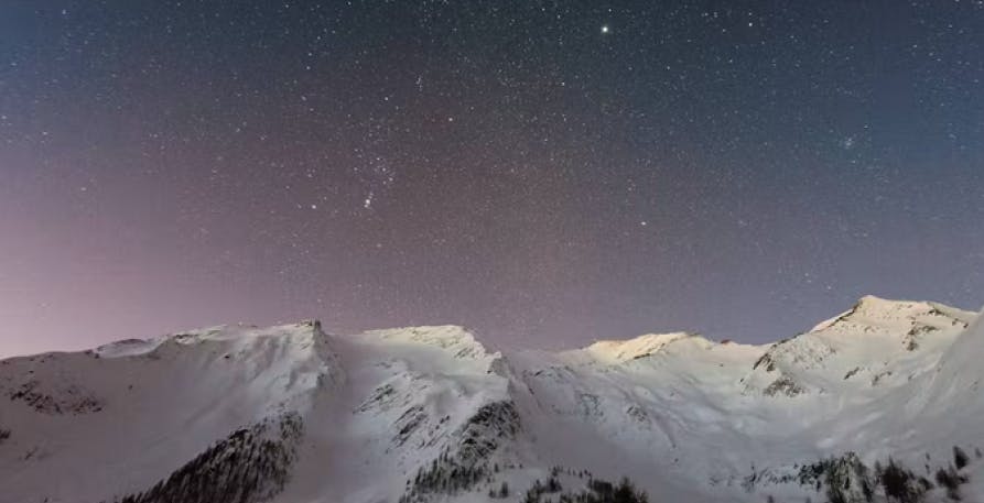 snowcap mountain in starry sky