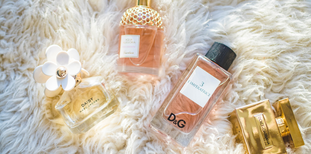 perfume bottles on white shaggy rug