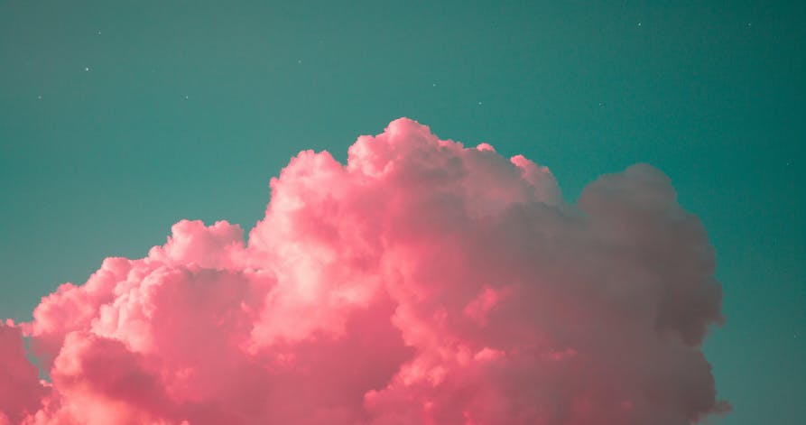 pink clouds against teal sky