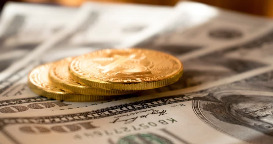 USD $100 bills and gold coins