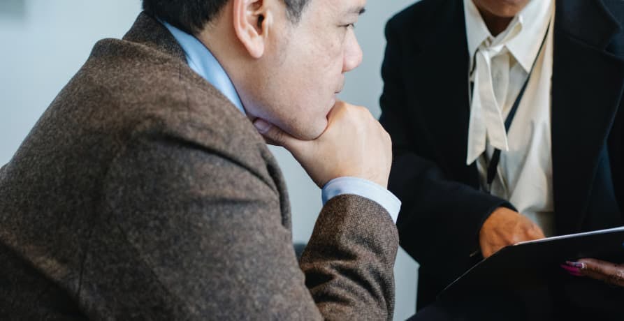 man in a suit looking at a report