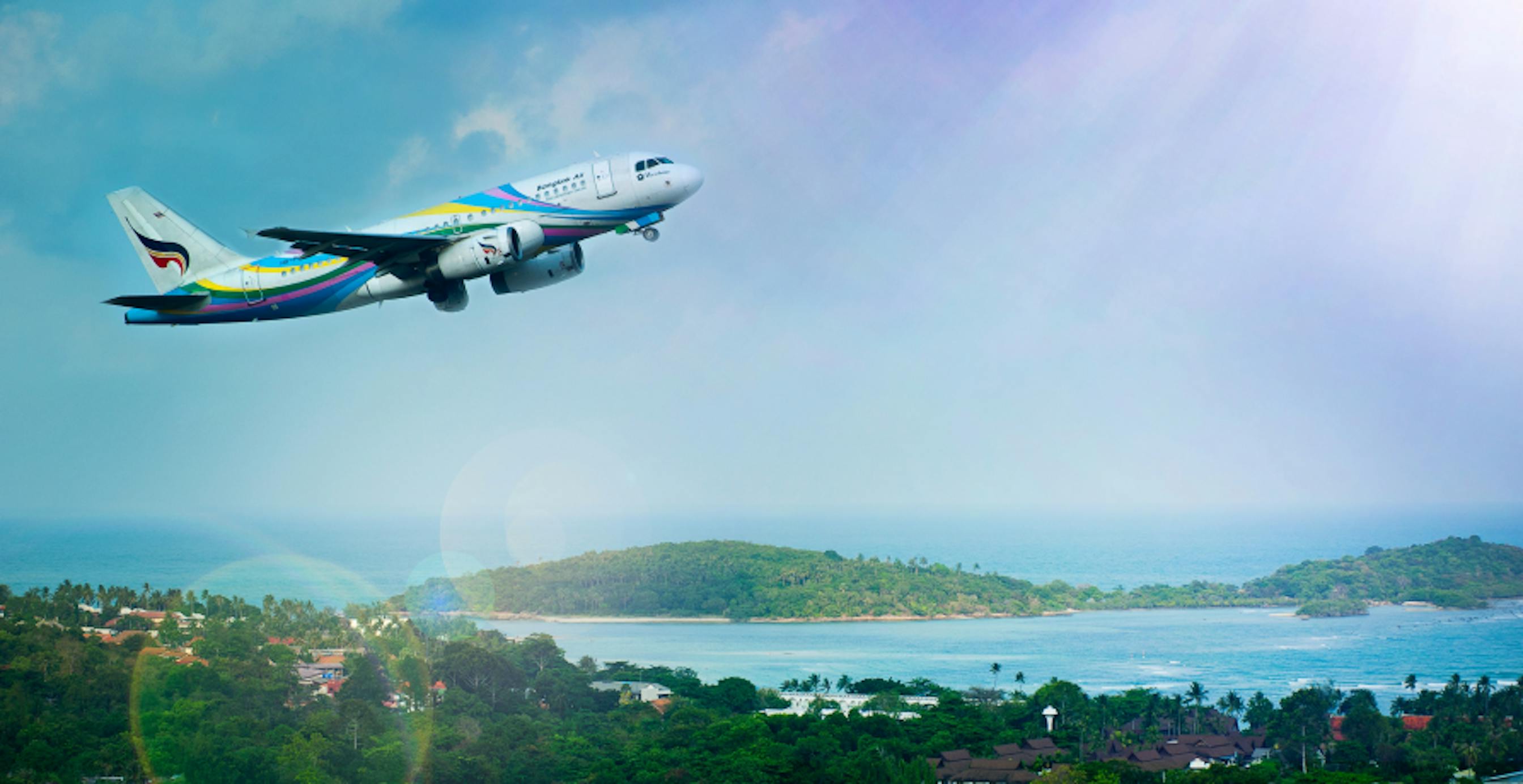plane flying over island