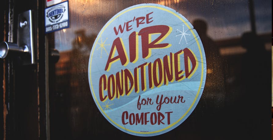 Affiche indiquant la présence d'air conditionné dans un commerce