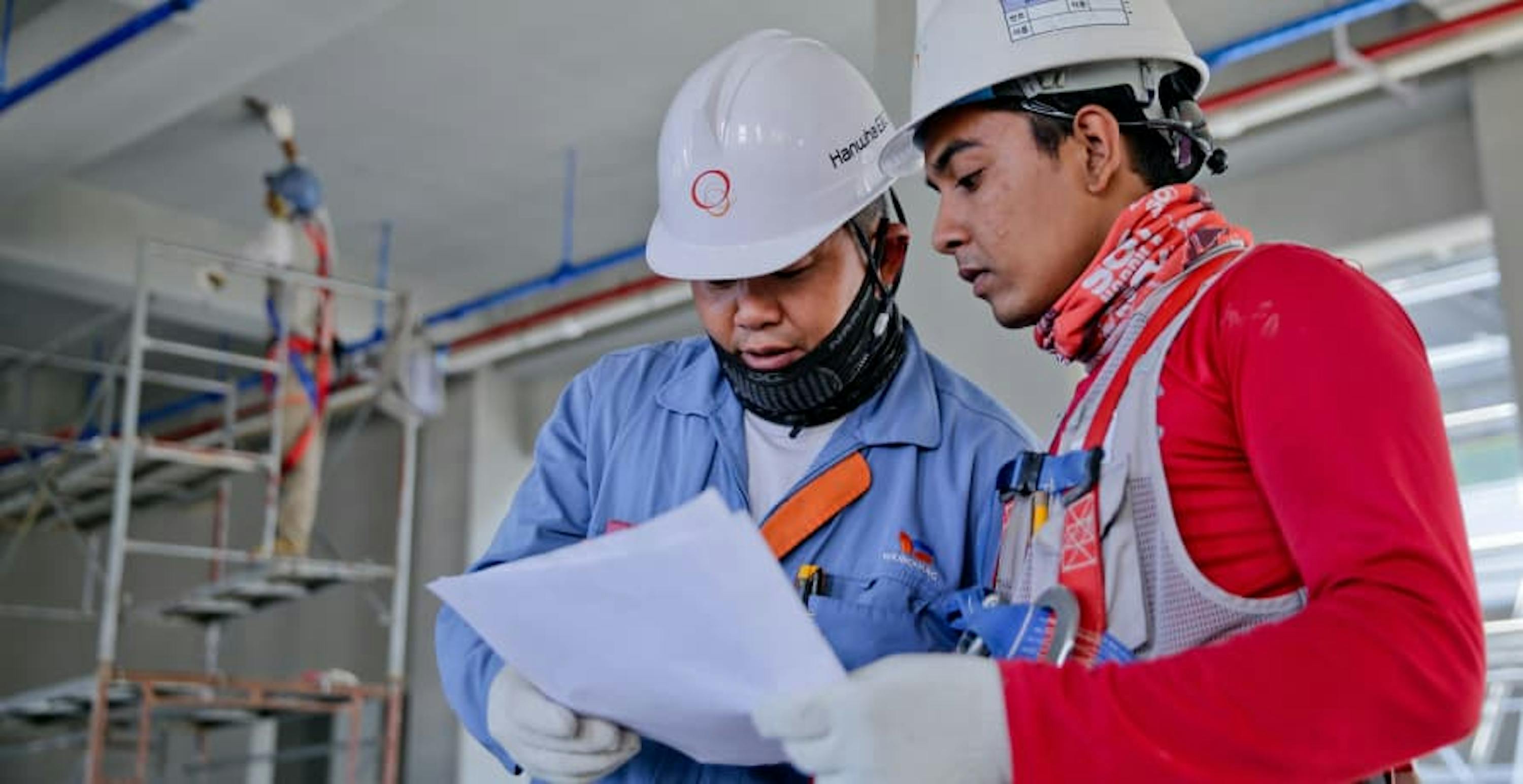 two men looking at building designs 