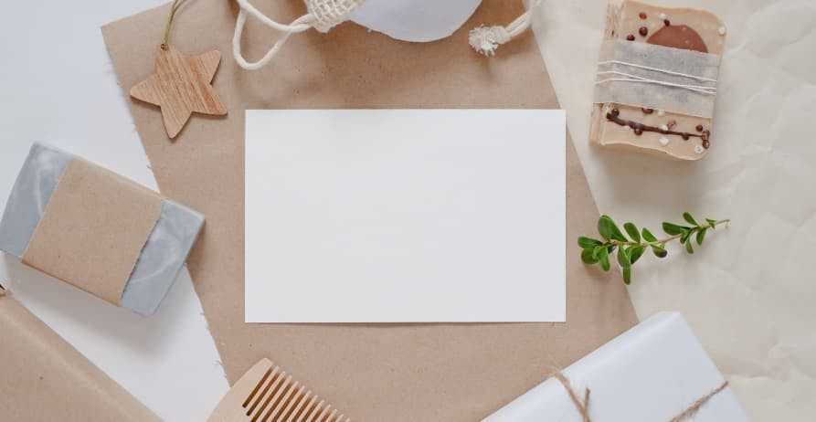 blank white paper near sustainable packaging