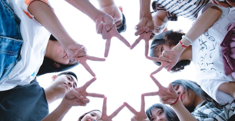 people putting their index fingers together to make a star