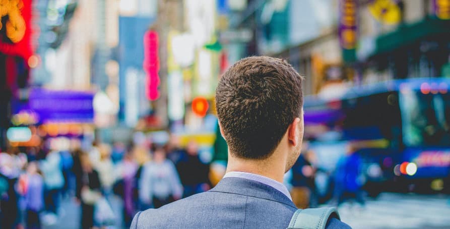 young man standing in times square nyc