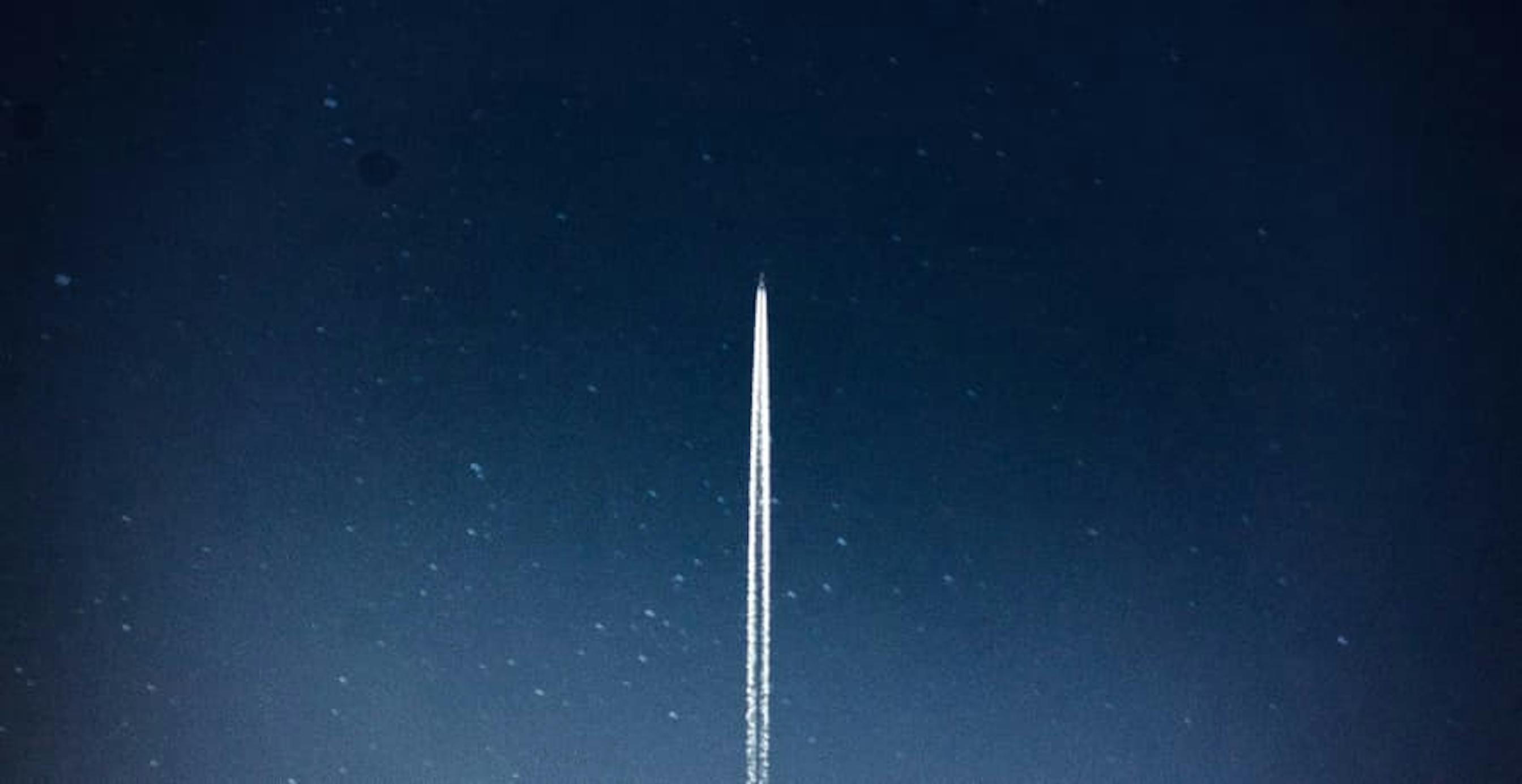 rocket launching into dark starry sky