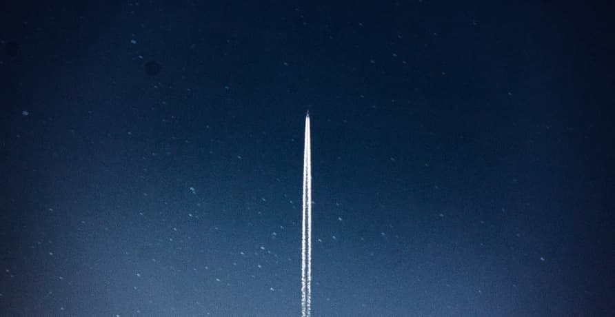 rocket launching into dark starry sky