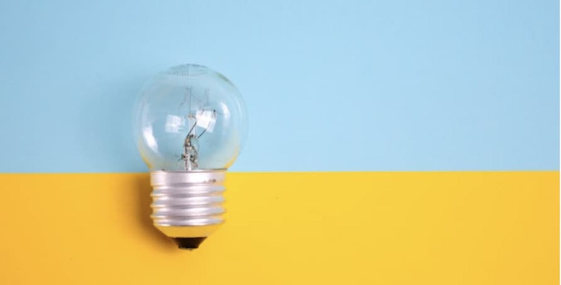 light bulb behind light blue and yellow background