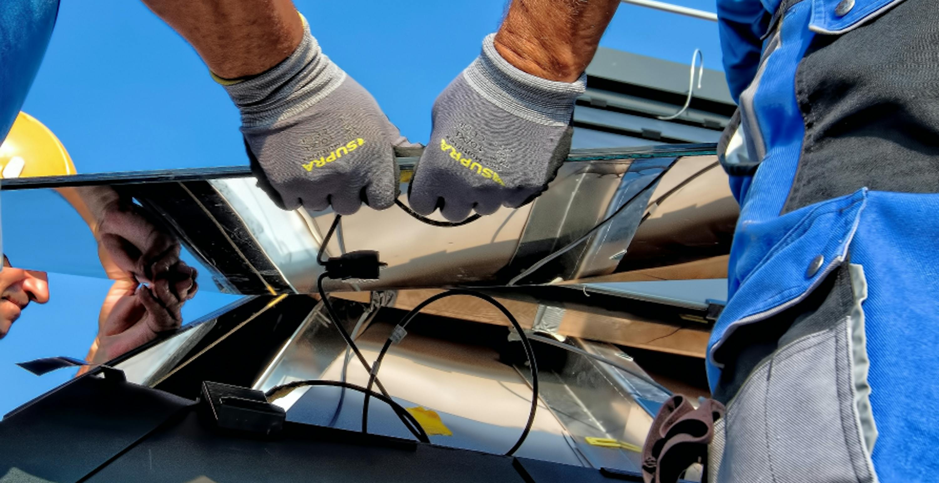 people assembling a solar panel