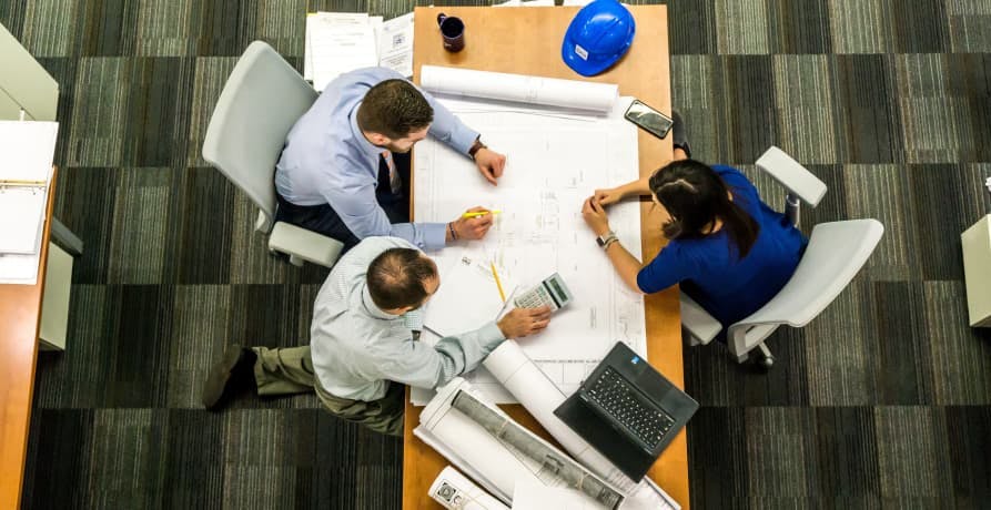 team working on a project at an office desk