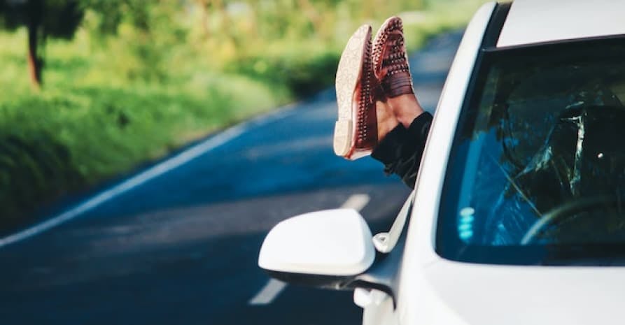 person sticking feet out the window
