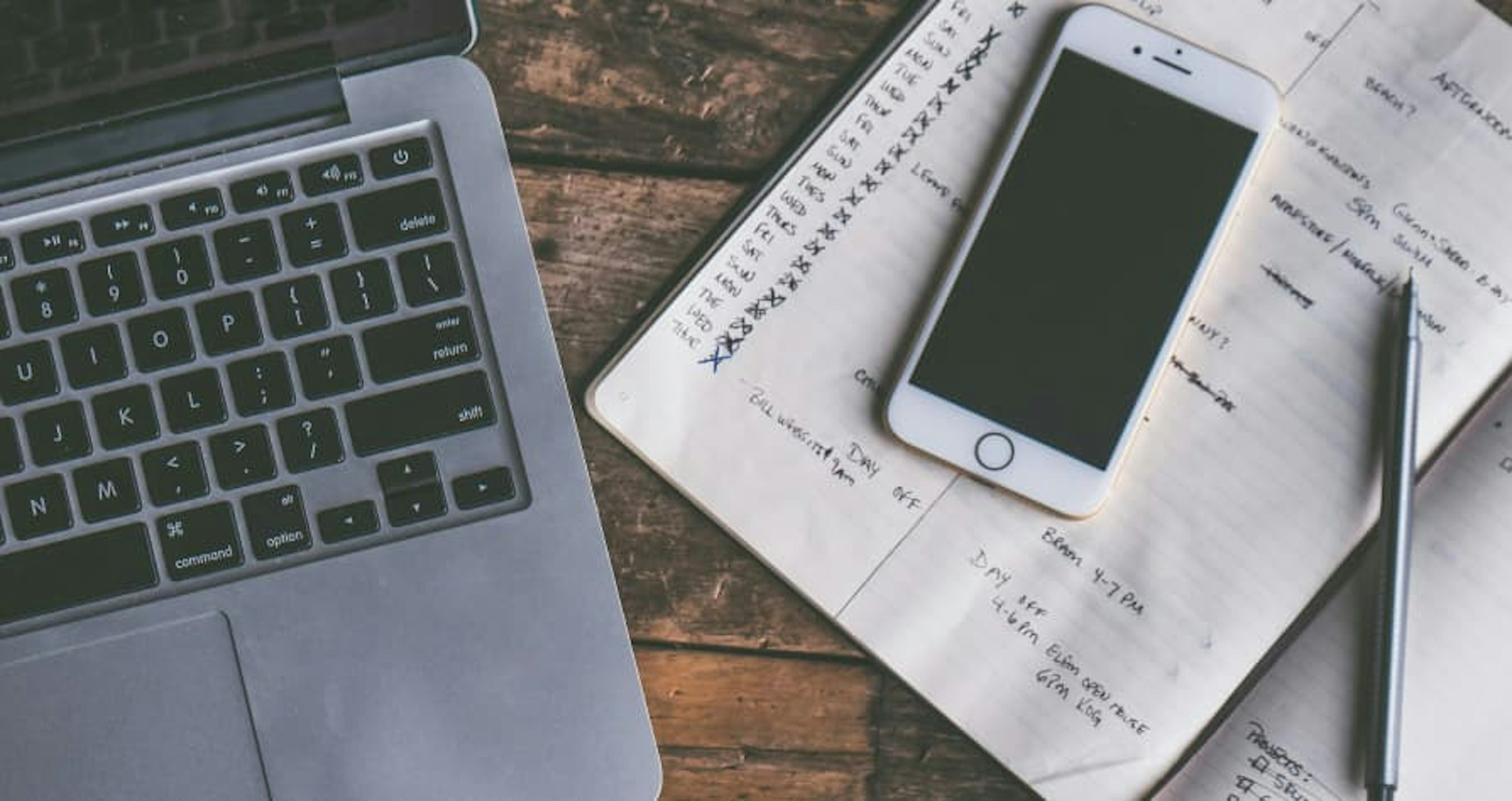 laptop and iphone with notepad