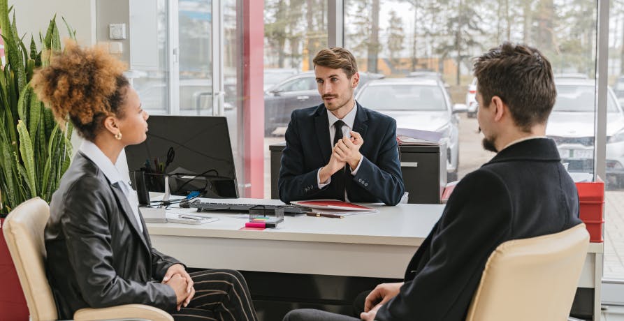 people in a meeting at a desk